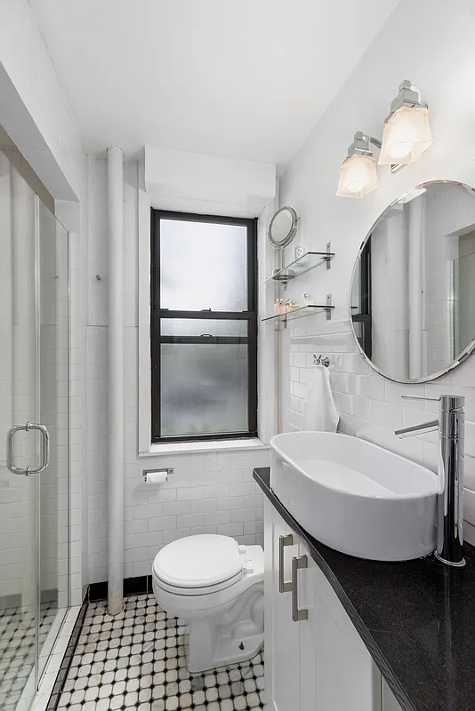 bathroom with shower and a frosted window