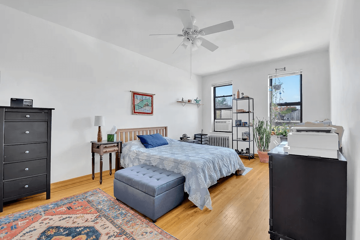 bedroom with two windows and a ceiling fan