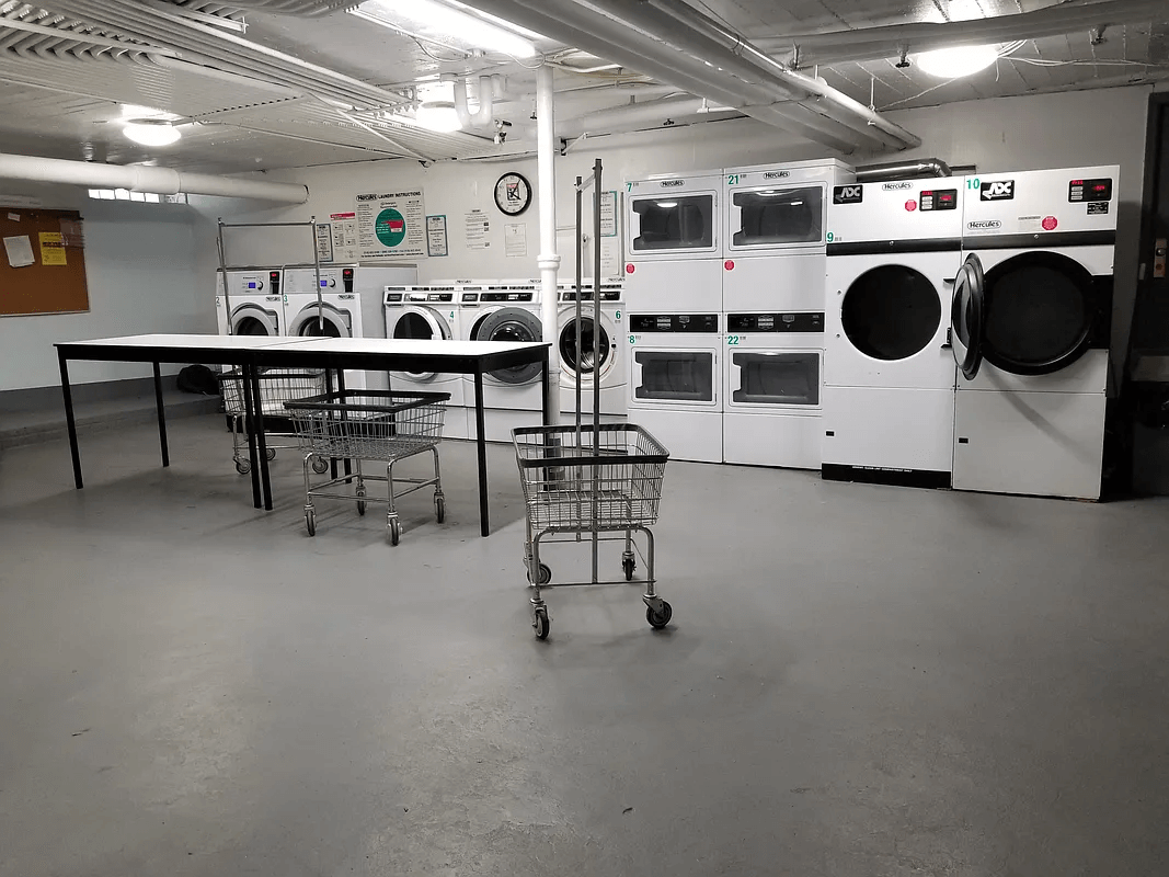 basement laundry room with multiple machines