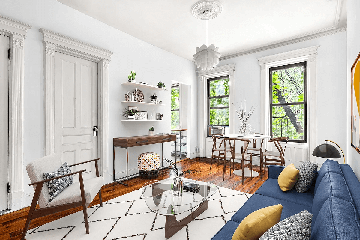 virtually staged living and dining area with two windows and a door to kitchen