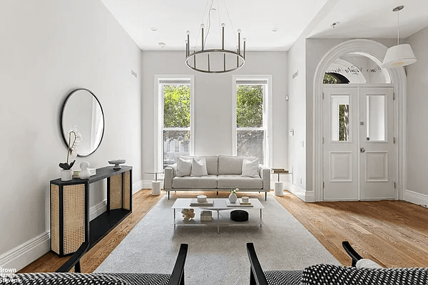 parlor with wood floors and a chandelier