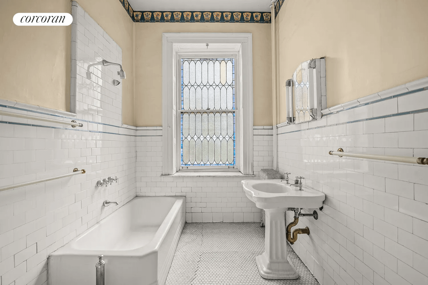 bathroom with vintage white subway tile and a stained glass window