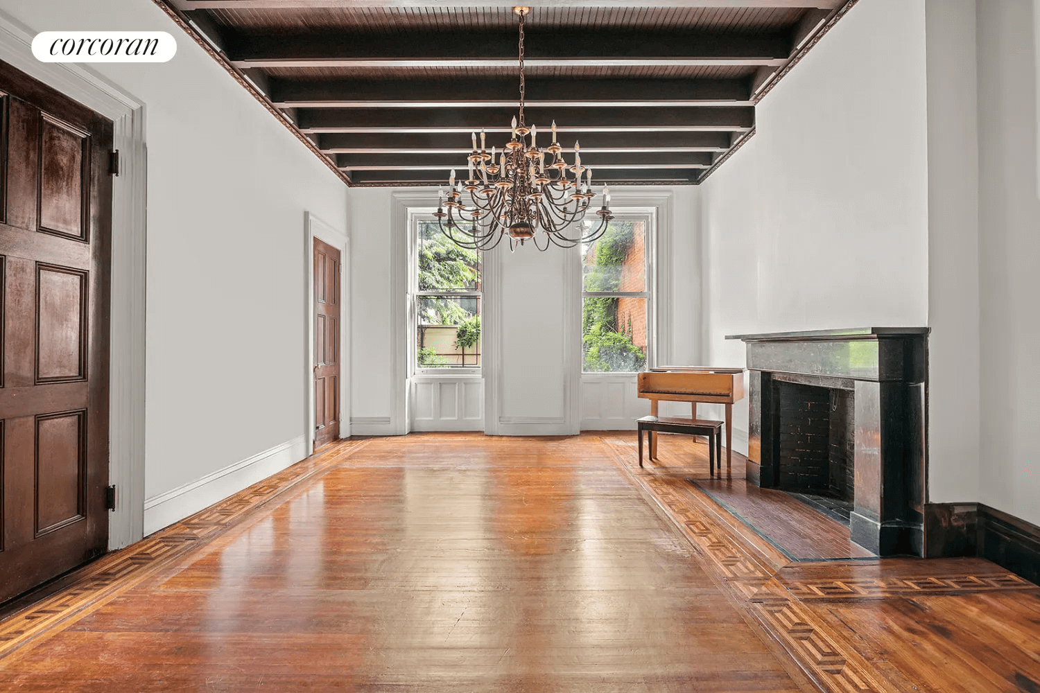 dining room with marble mantel and beamed ceiling