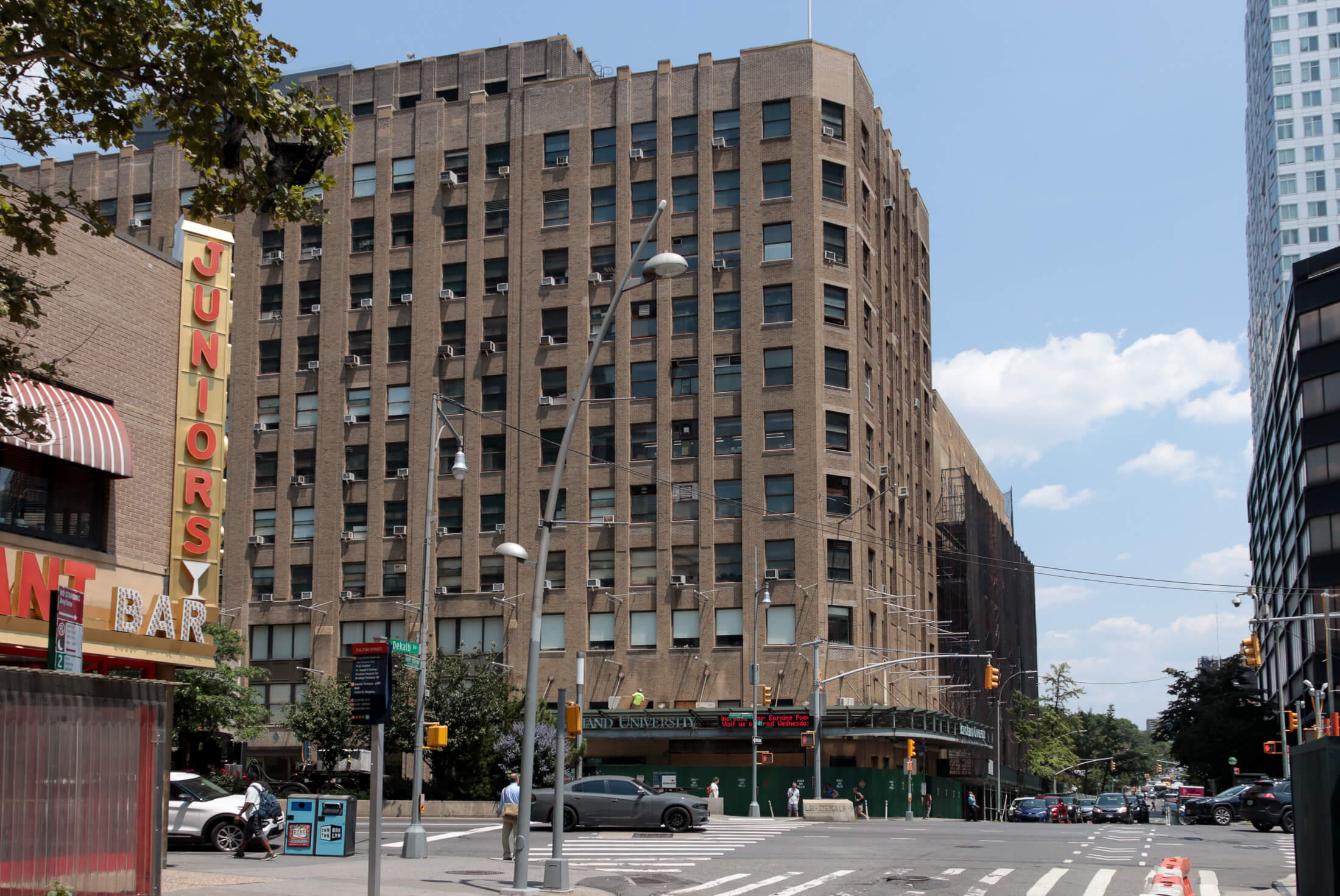 exterior of the building with a construction fence around the first level