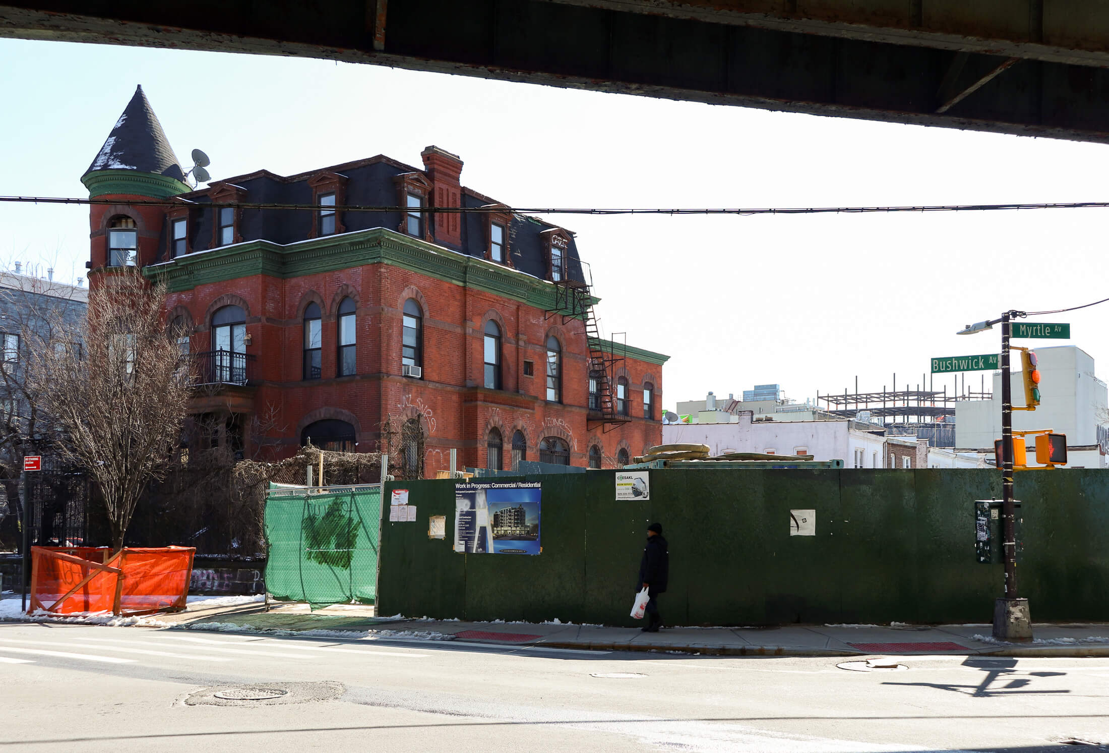 the house with a construction fence next to it