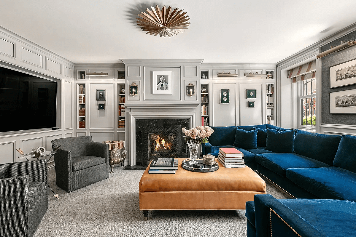 den on garden level with paneling and fireplace