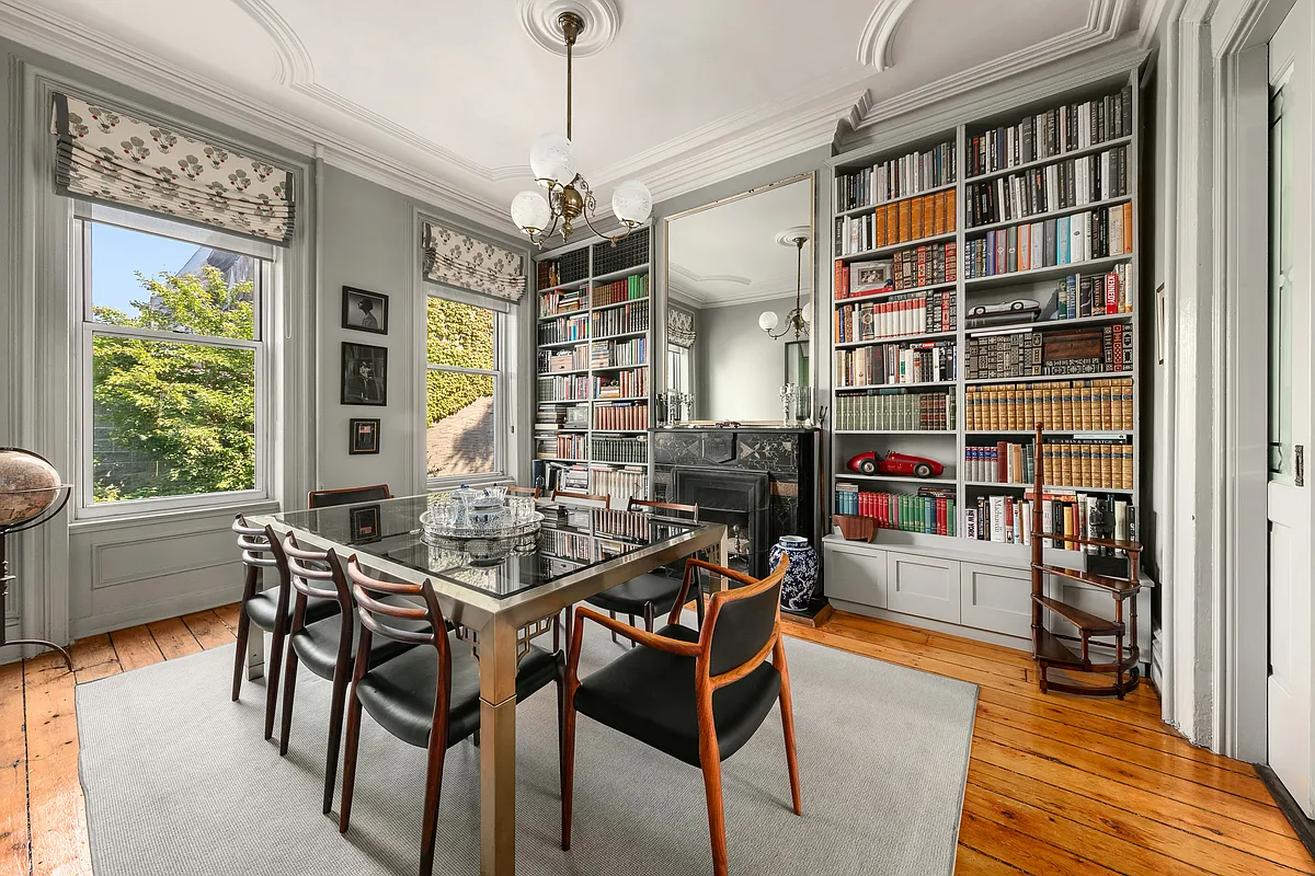 dining room with black marble mantel and built-ins