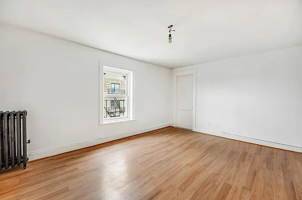 bedroom with wood floor and one window
