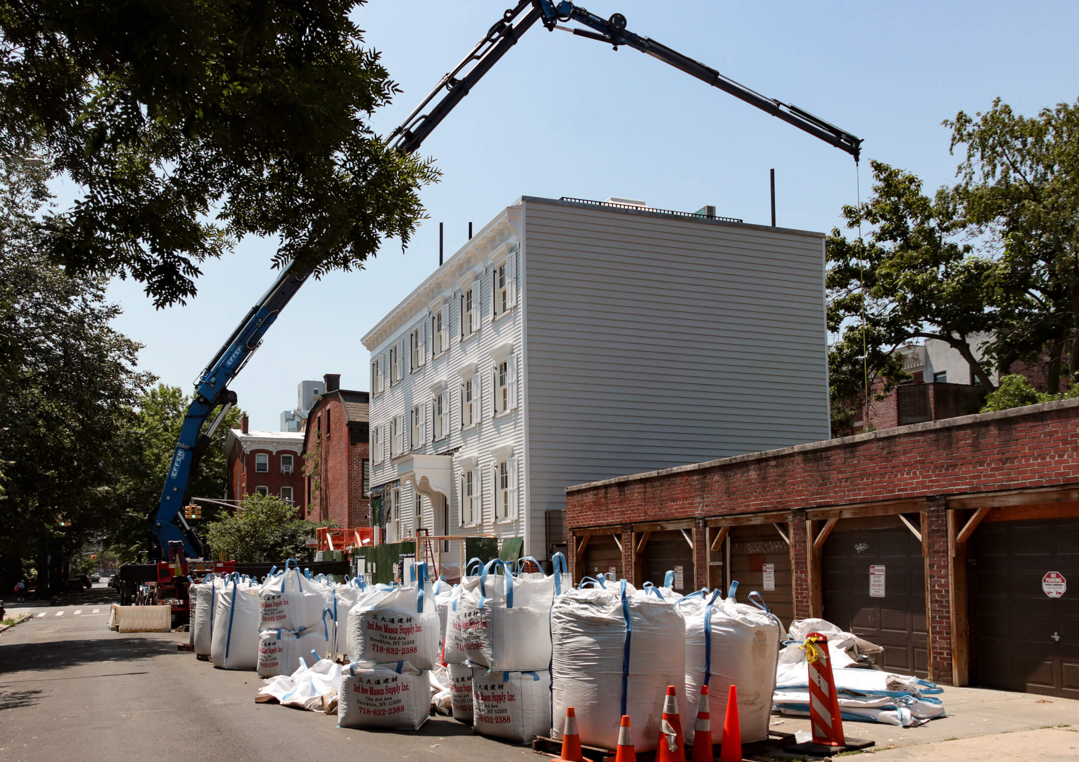 a crane hovers over the wood frame buidlings