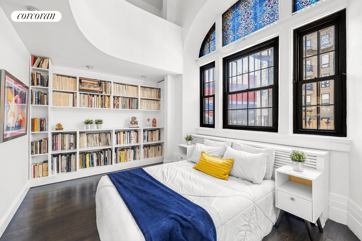 bedroom with a stained glass window and built-in bookcases