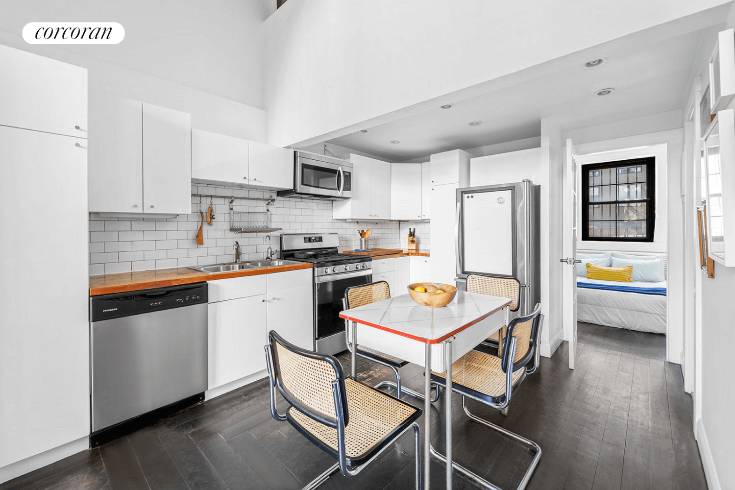 kitchen with white cabinets and white subway tile walls