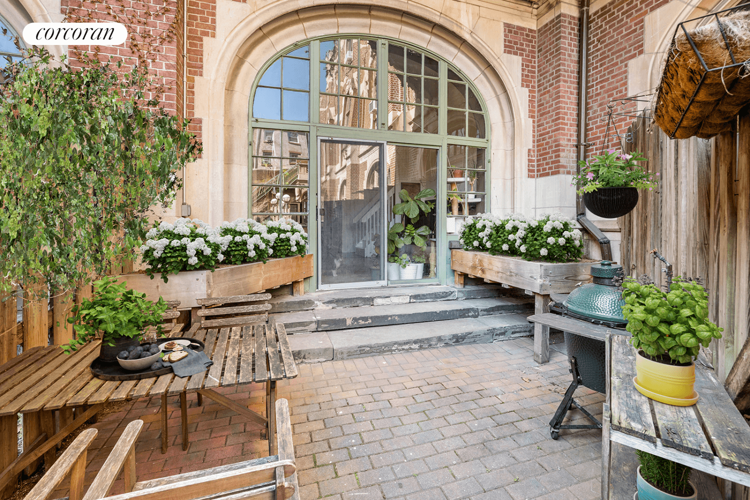 patio with brick paving and a wood fence