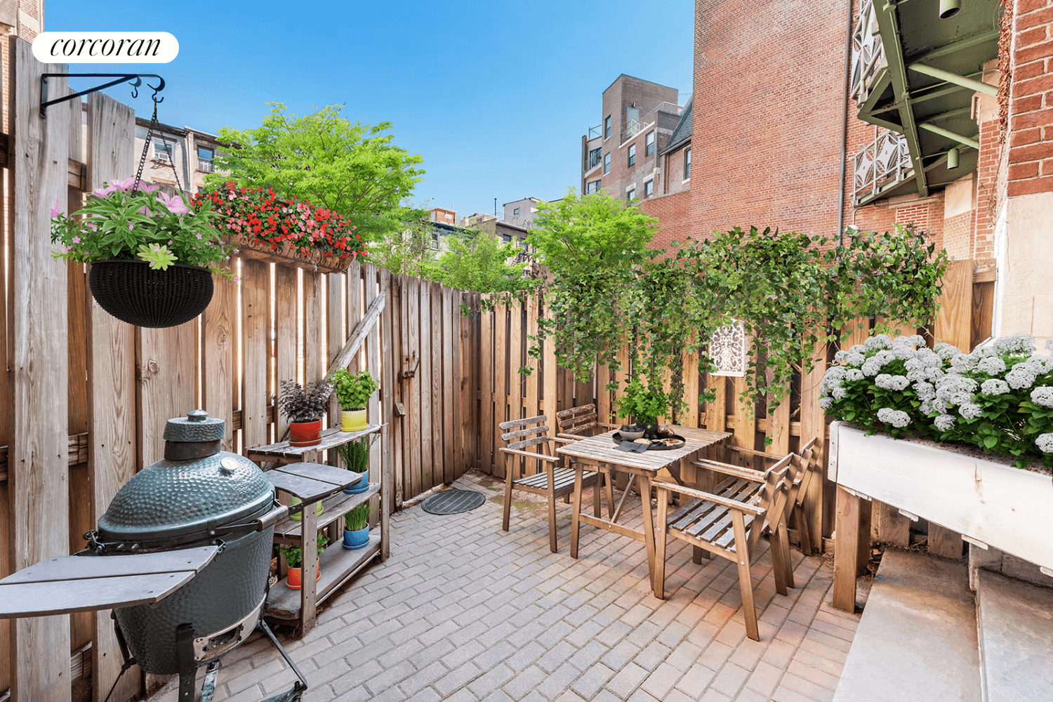 patio with wood fence and gate leading to building courtyard