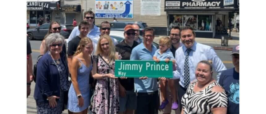 people gathered around the jimmy prince way sign