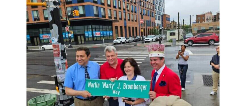 people gathered around a street sign