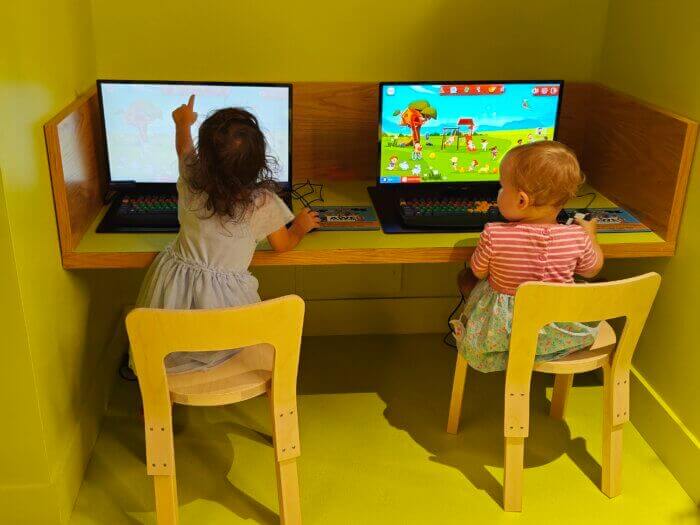 children sitting in front of computers
