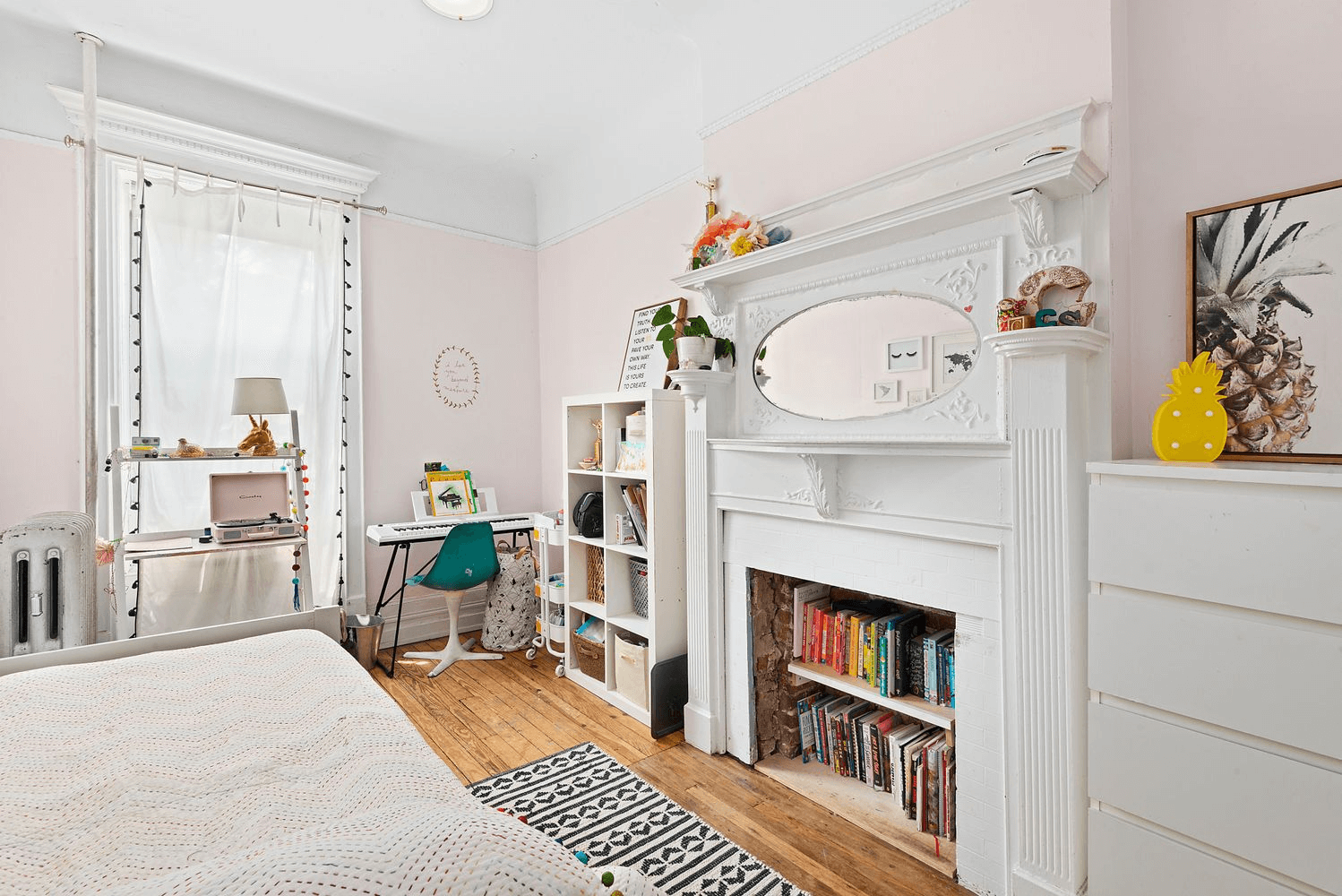 bedroom with white painted mantel with mirror