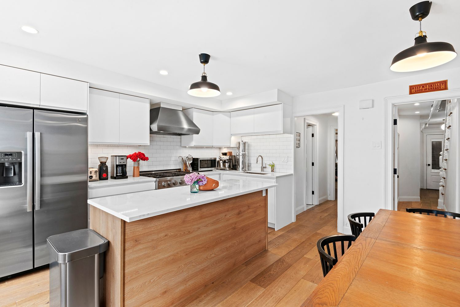 kitchen with white cabinets and a wood island