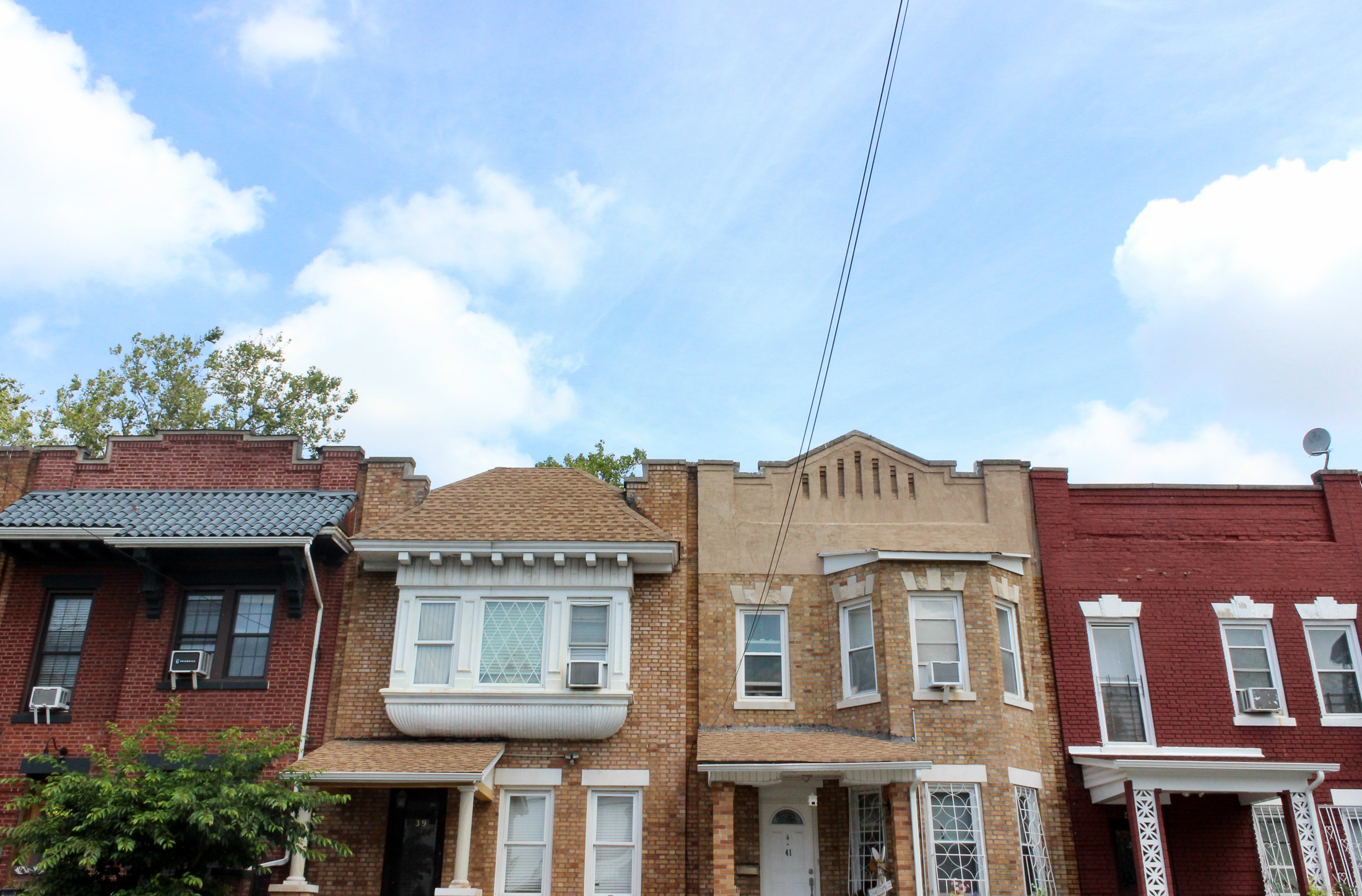 brick row houses and a blue sky in cypress hills