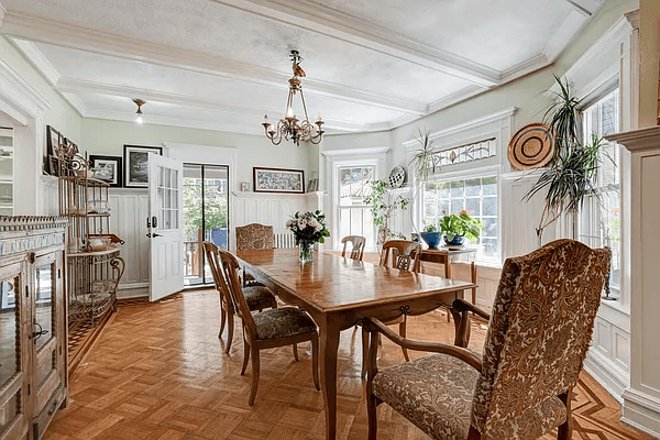 dining room with wainscoting and a beamed ceiling all painted white