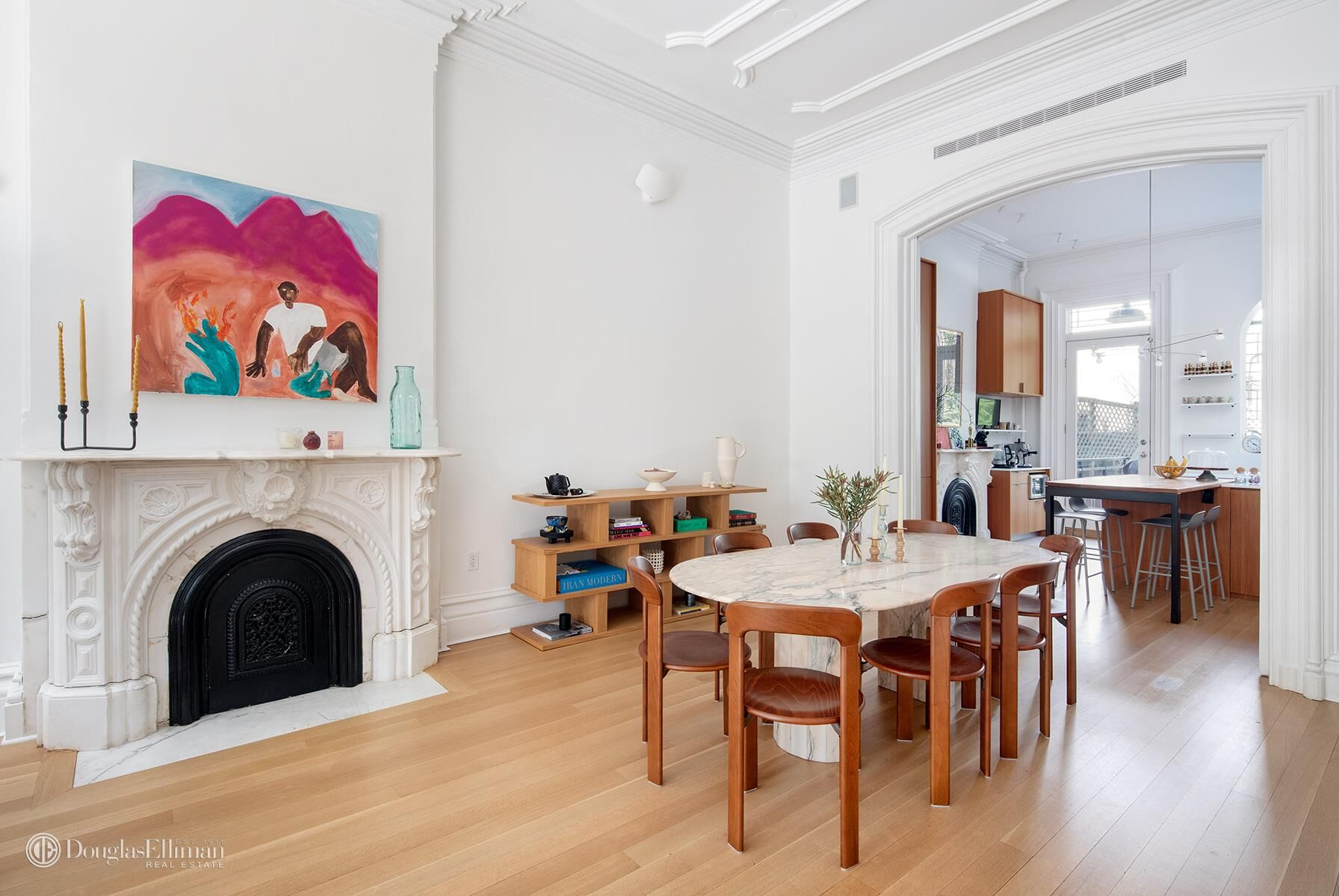 brooklyn open houses - dining room with a marble mantel and view into modern kitchen