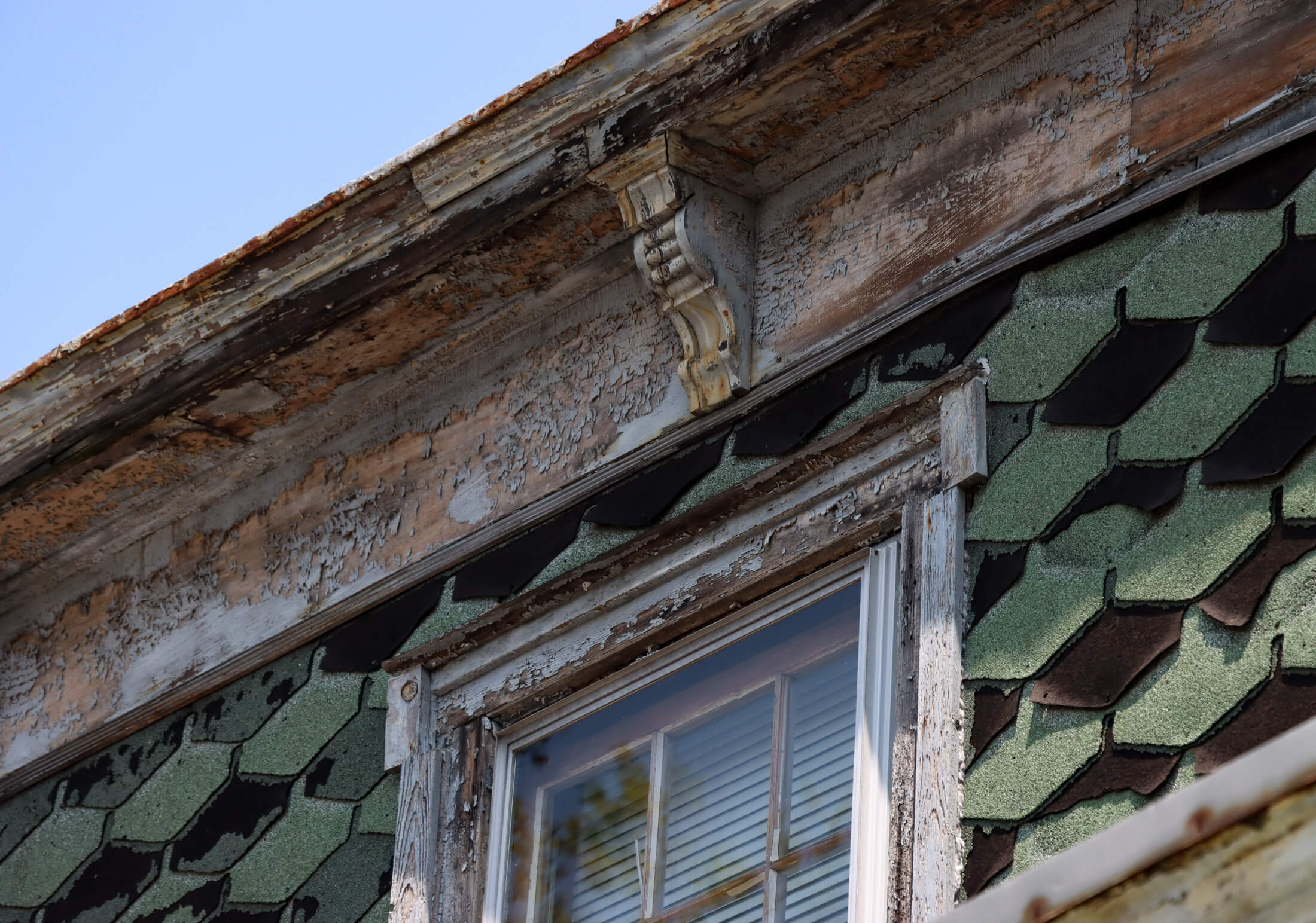 a closeup of a decorative bracket at the cornice