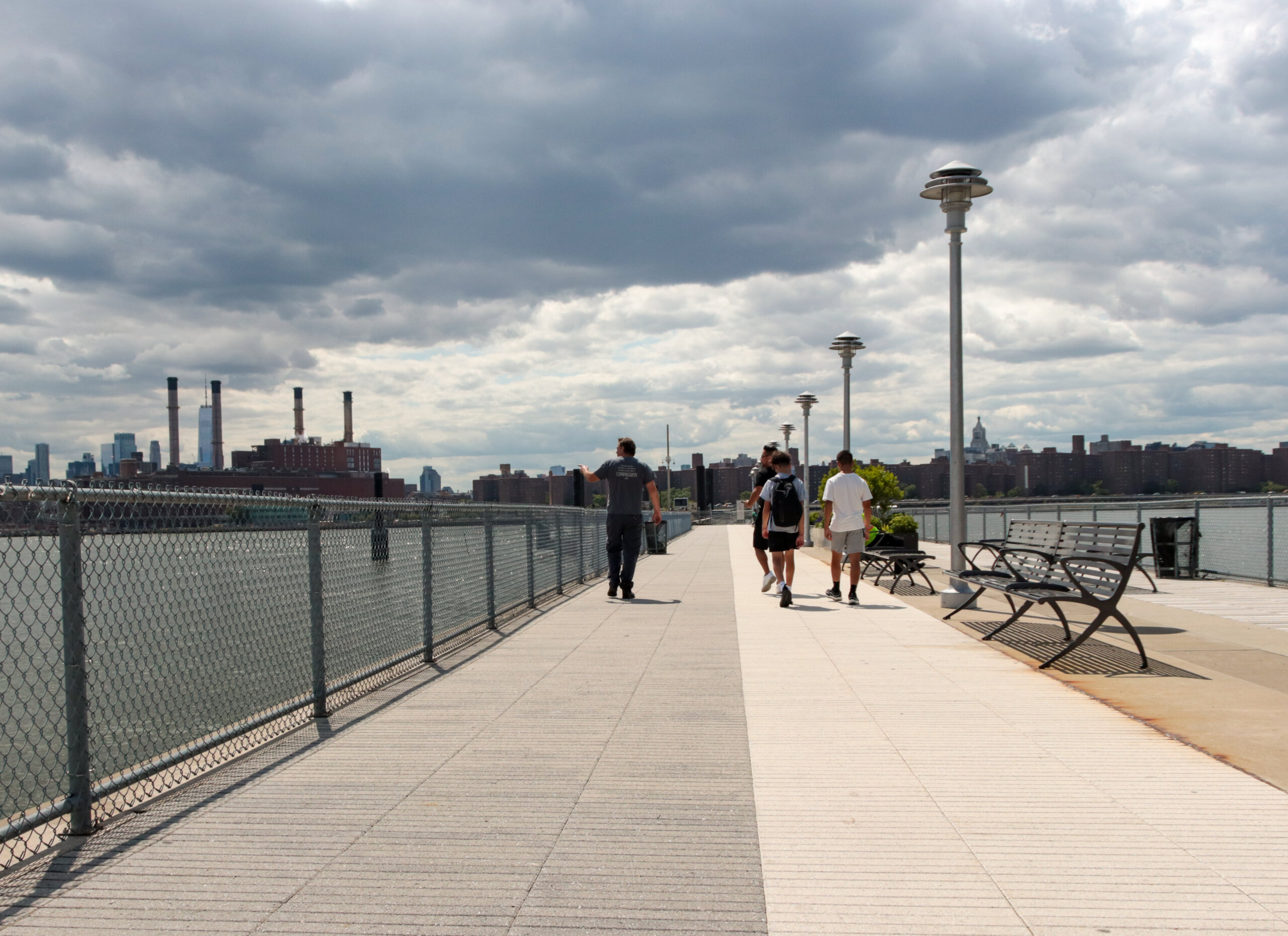 people walking on pier toward ferry in greenpoint