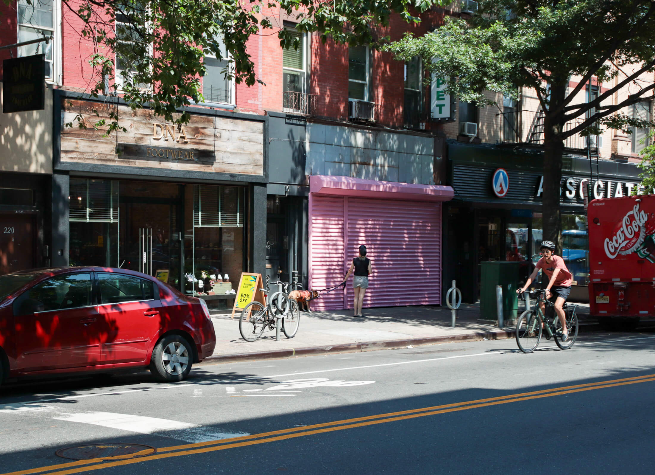 view of the pink roll down gate in front of the storefront