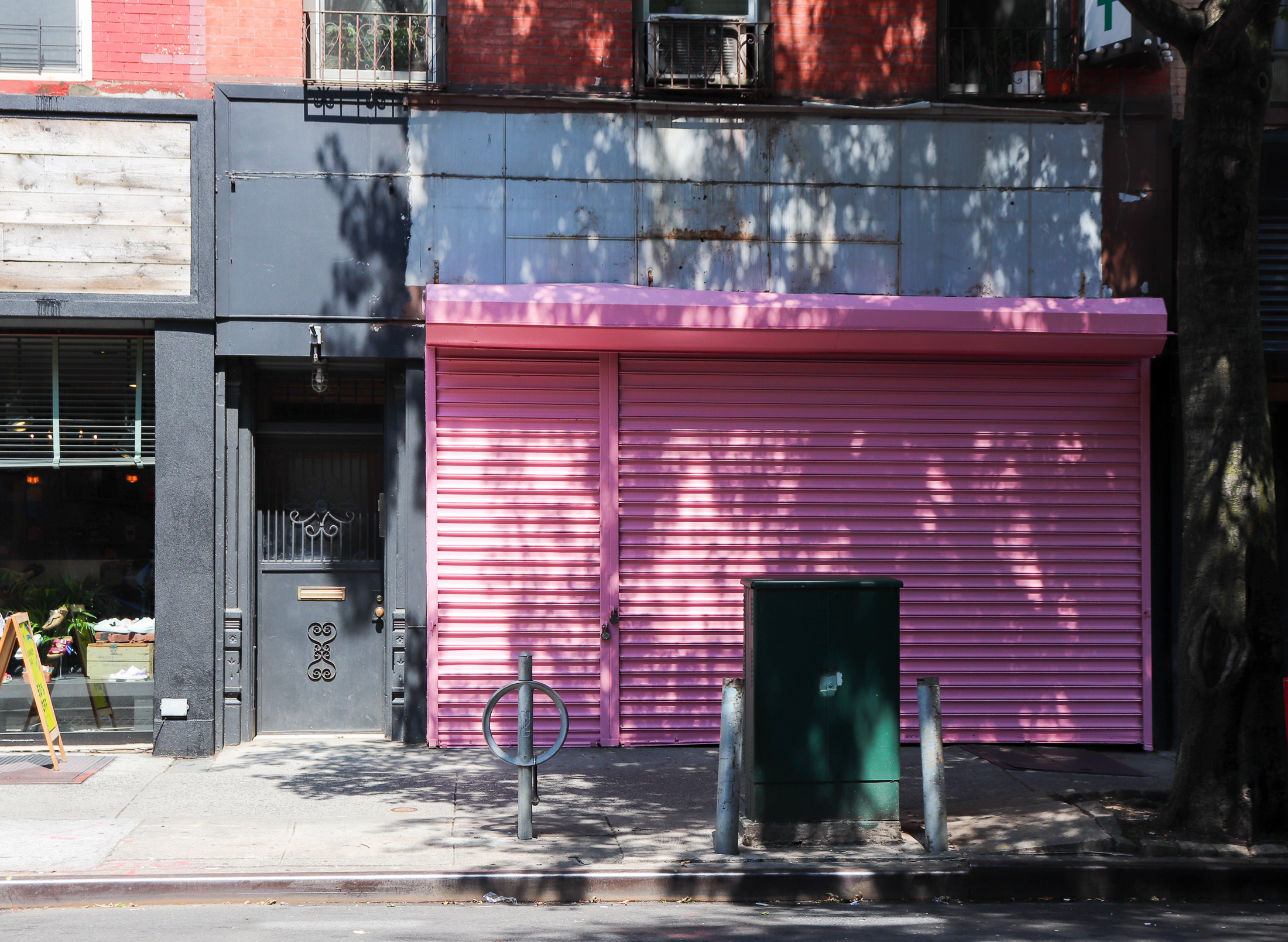 The Ripped Bodice pink roll down gate in front of the storefront