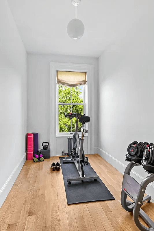 a narrow bedroom set up as a gym