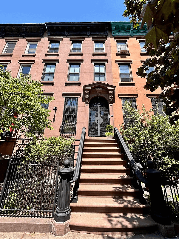 the brownstone exterior with a stoop