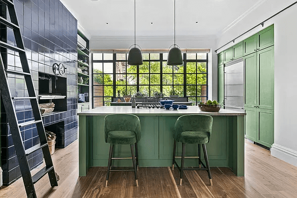 the green colored island and kitchen cabinets