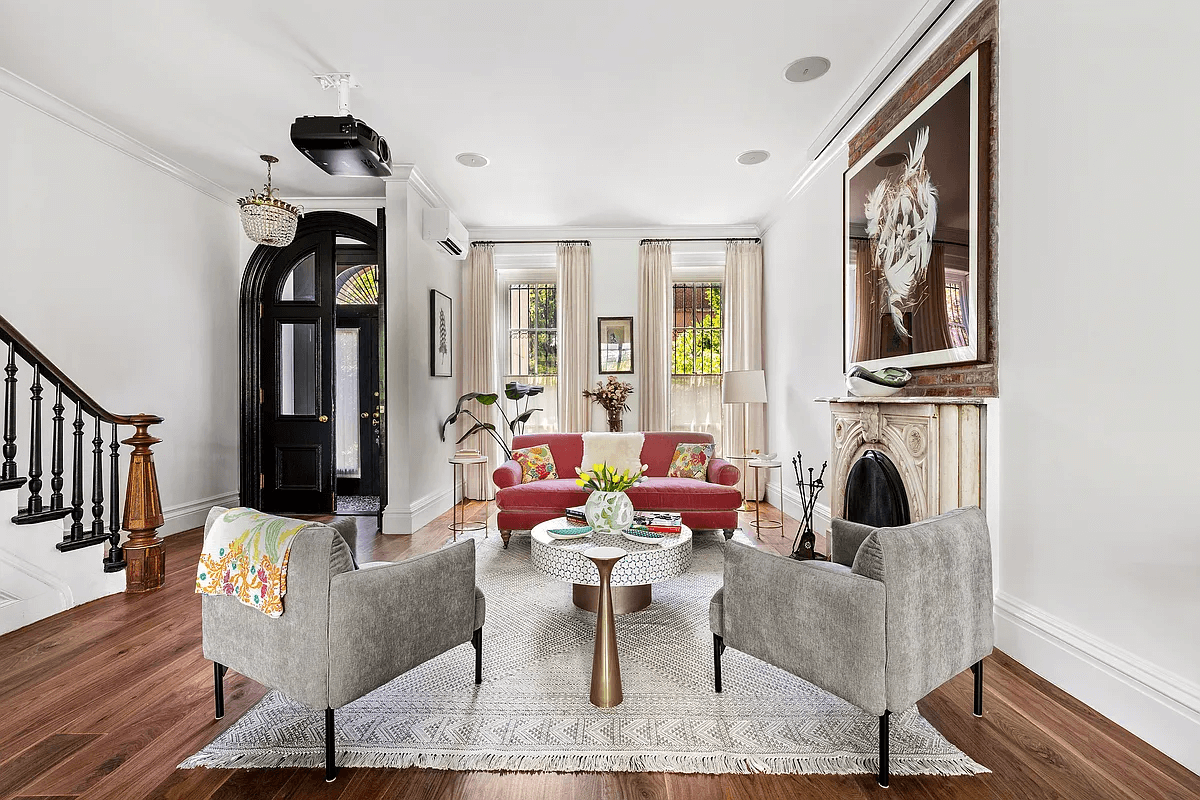 parlor with a marble mantel and a projector hanging from the ceiling