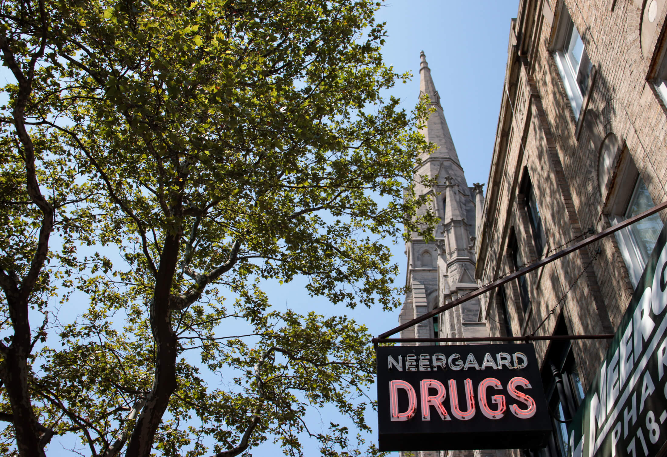 view of the steeple of Old First Reformed and the vintage sign at neergaard drugs