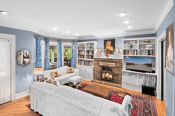 living room with recessed lighting and a brick fireplace