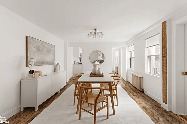 a staged dining room with wood floors and white walls