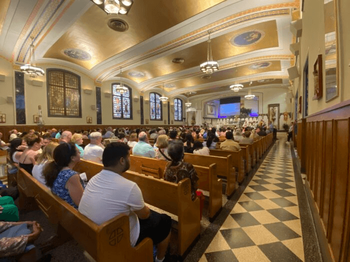 people sitting in pews inside church