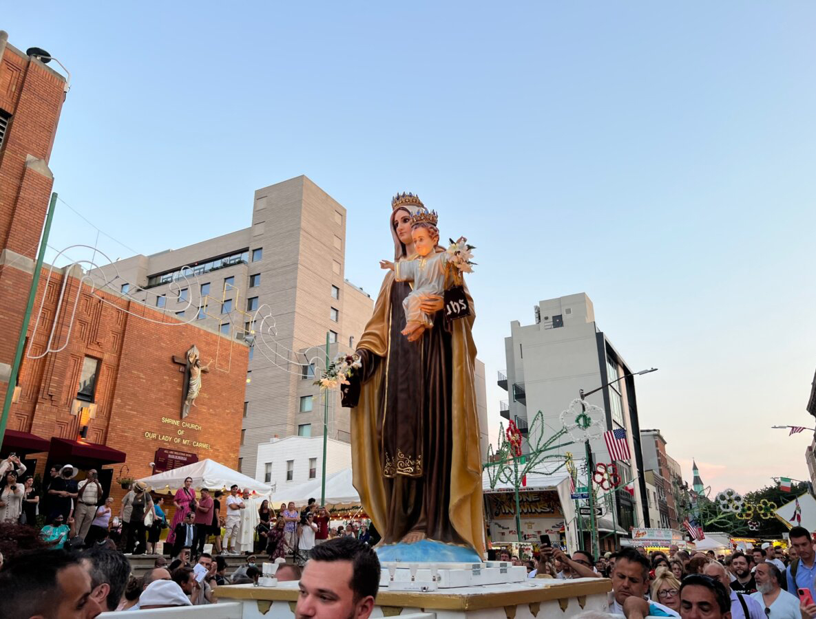 view of street festival with church in the background