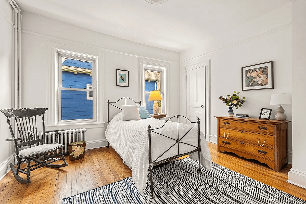 bedroom with wood floors and picture rail