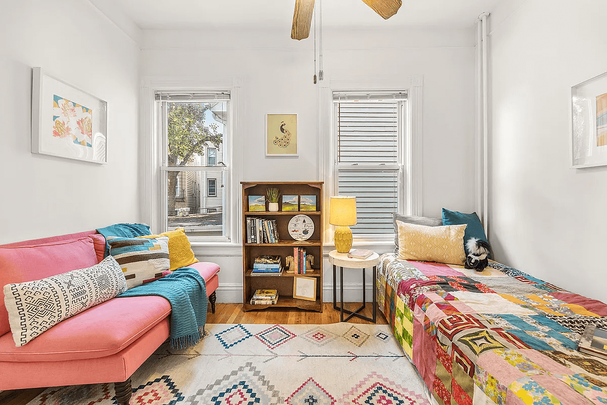 bedroom with two windows, picture rail and a ceiling fan