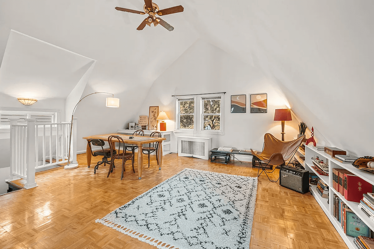 attic bedroom with ceiling fan