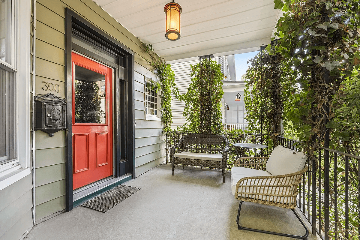 front porch with a red front door