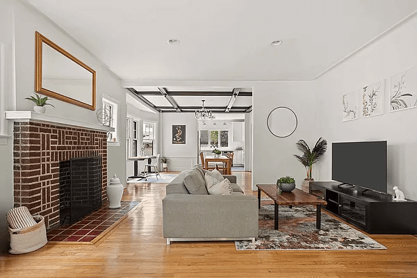 open house - living room with a brick mantel