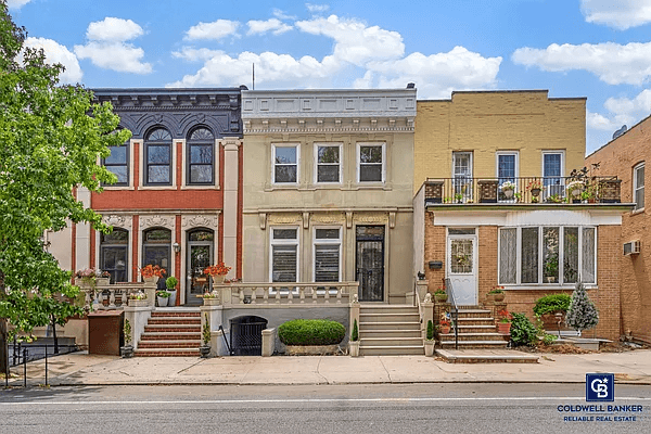 row house exterior with front terrace and bracketed cornice