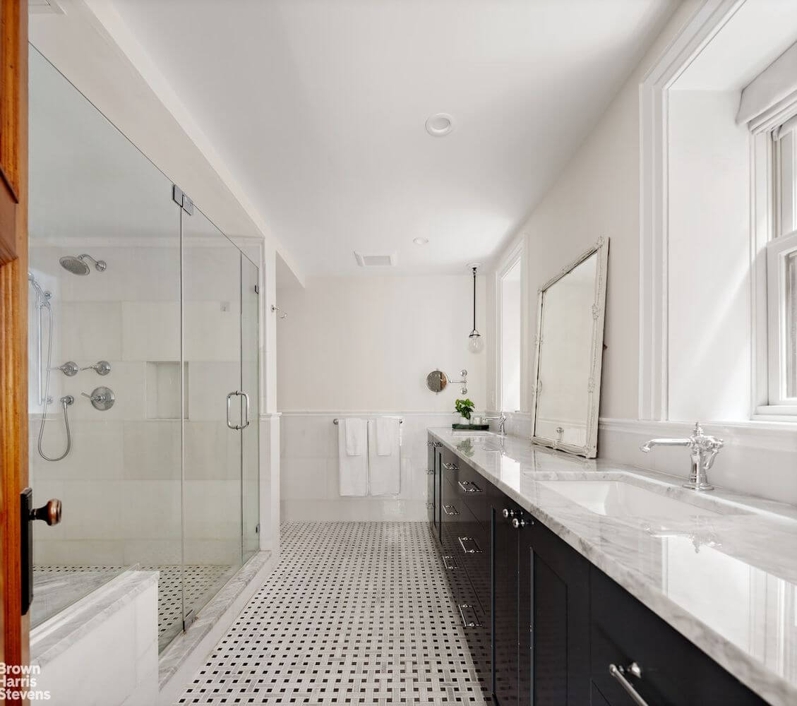 bathroom with double vanity and glass shower