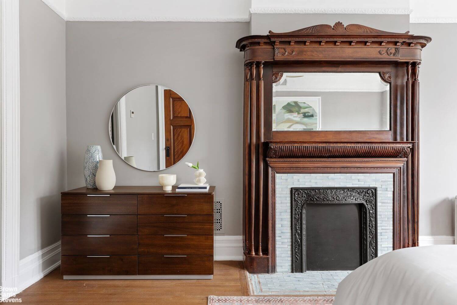 bedroom with a mantel with mirror