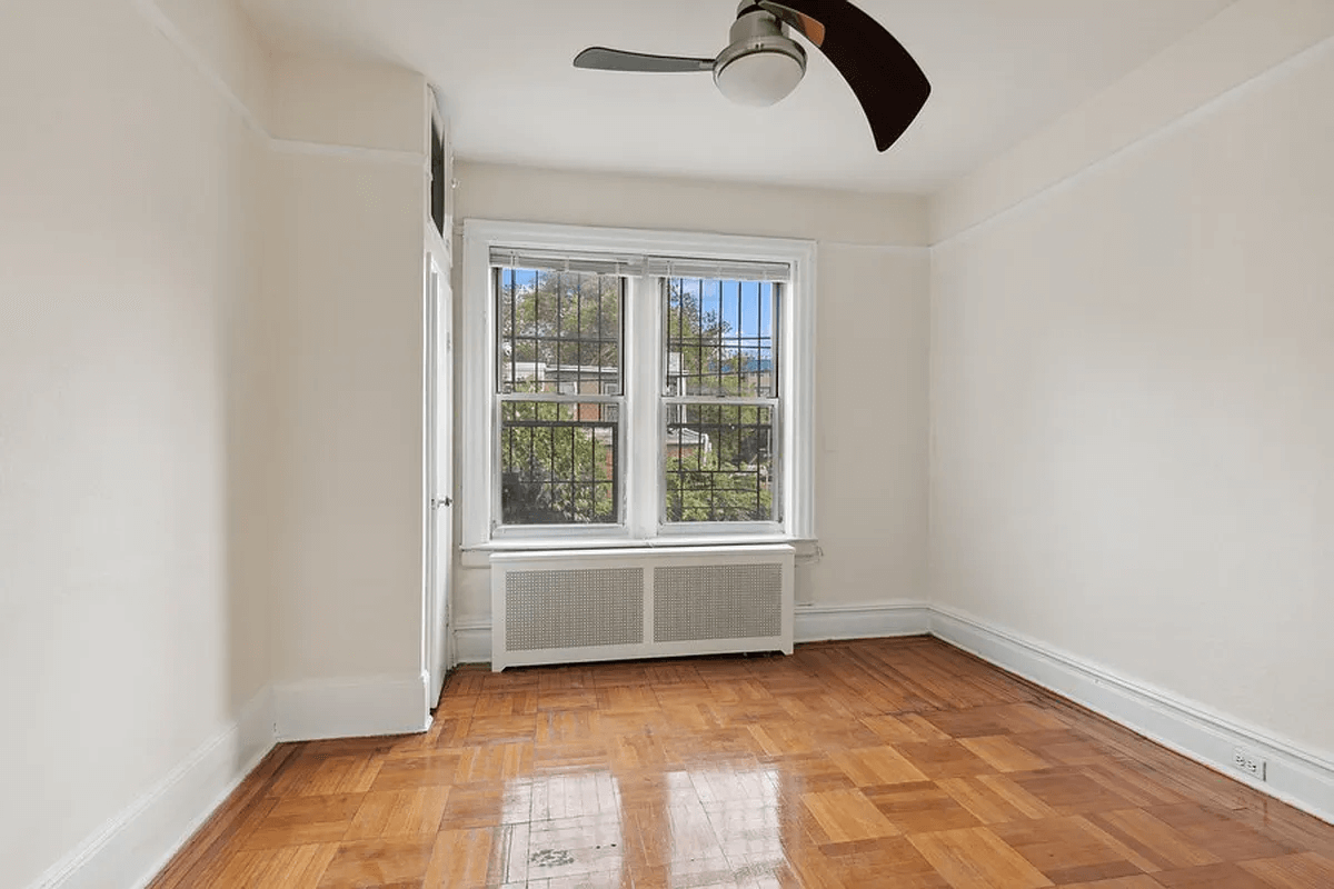 bedroom with parquet floor and a ceiling fan