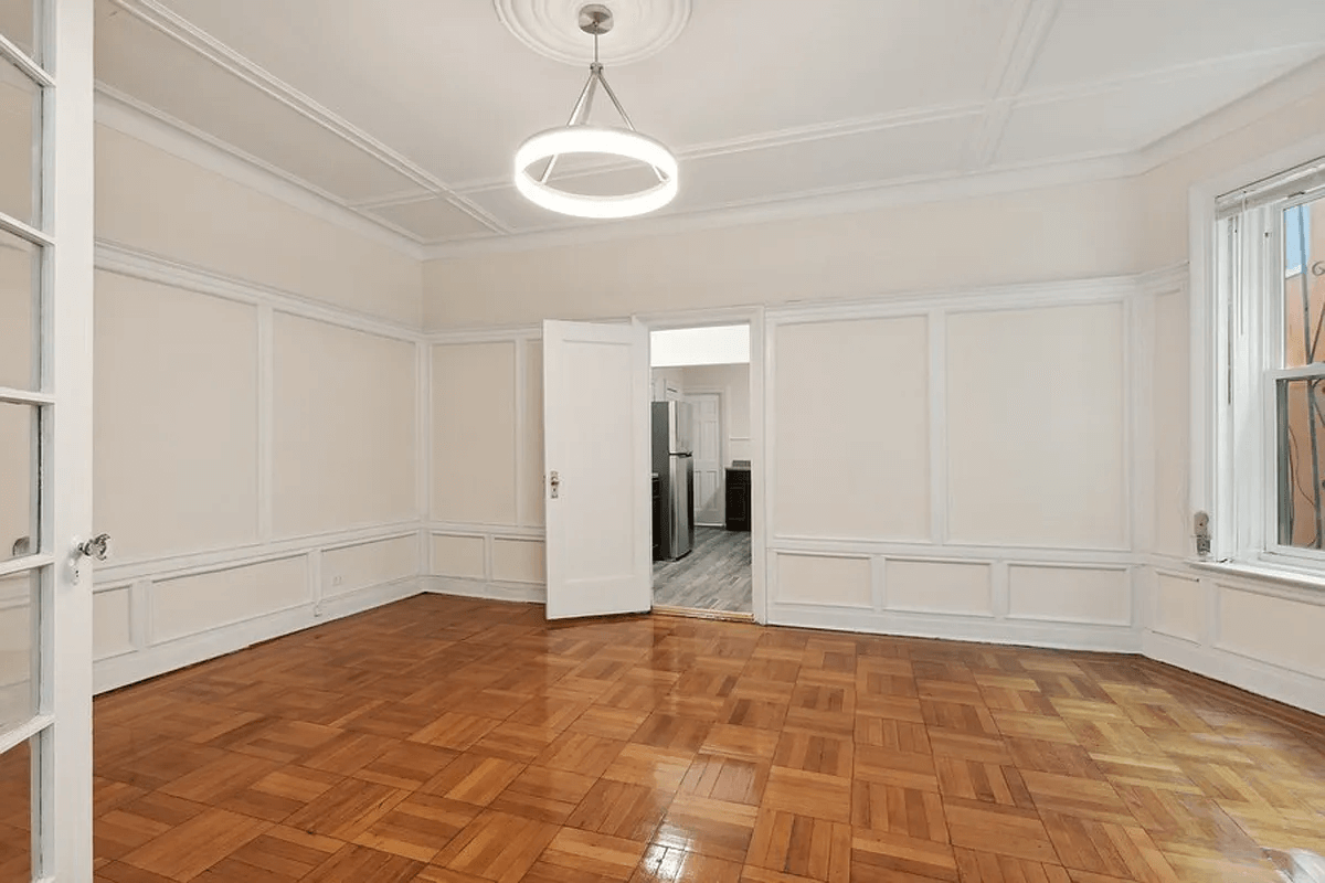 dining room with wainscoting and door into kitchen