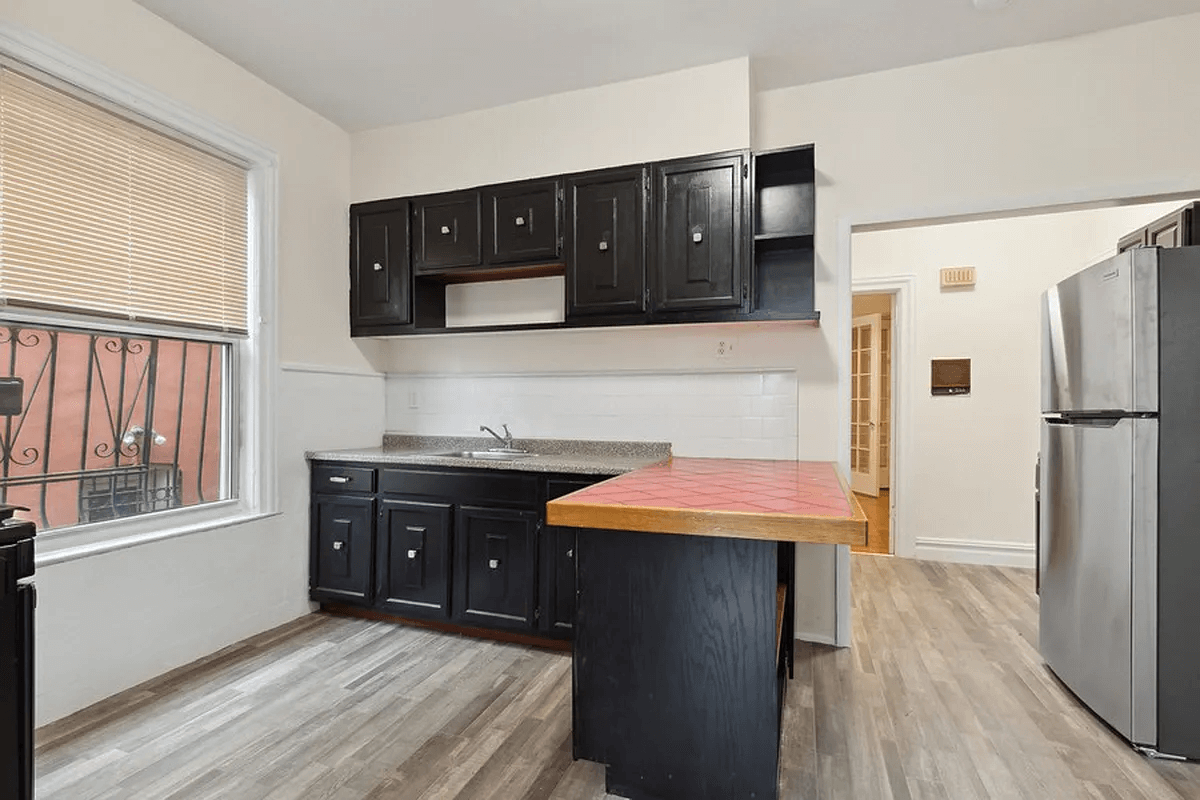 kitchen with vinyl floor, black cabinets