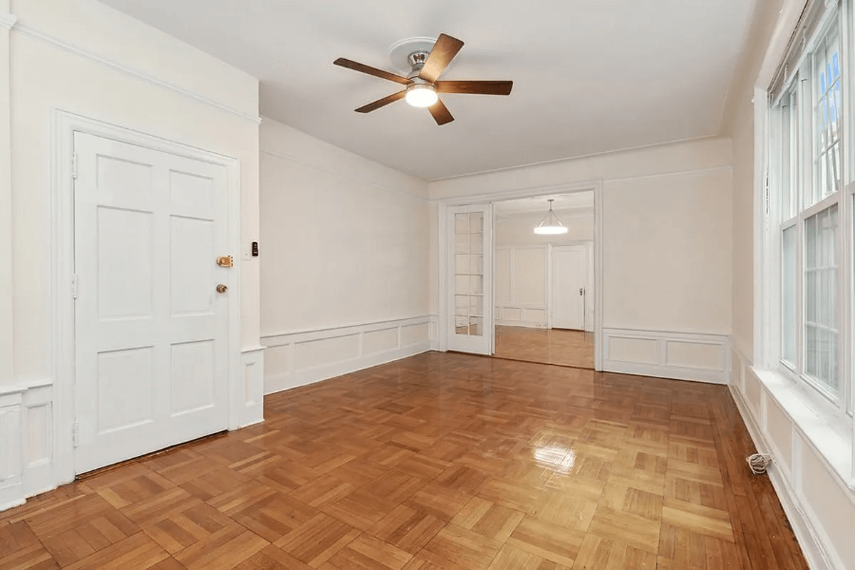 living room with parquet and french doors into the dining room